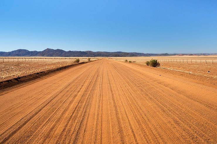 The smooth earth/dirt surface of the D707.